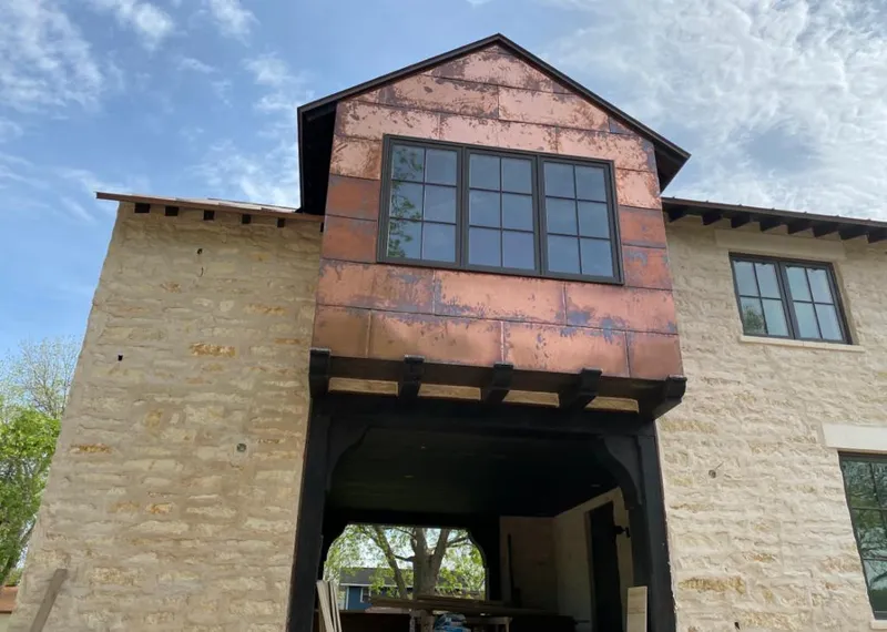 Copper metal panel facade on a stone building for Metal Roof Coating in Stowe